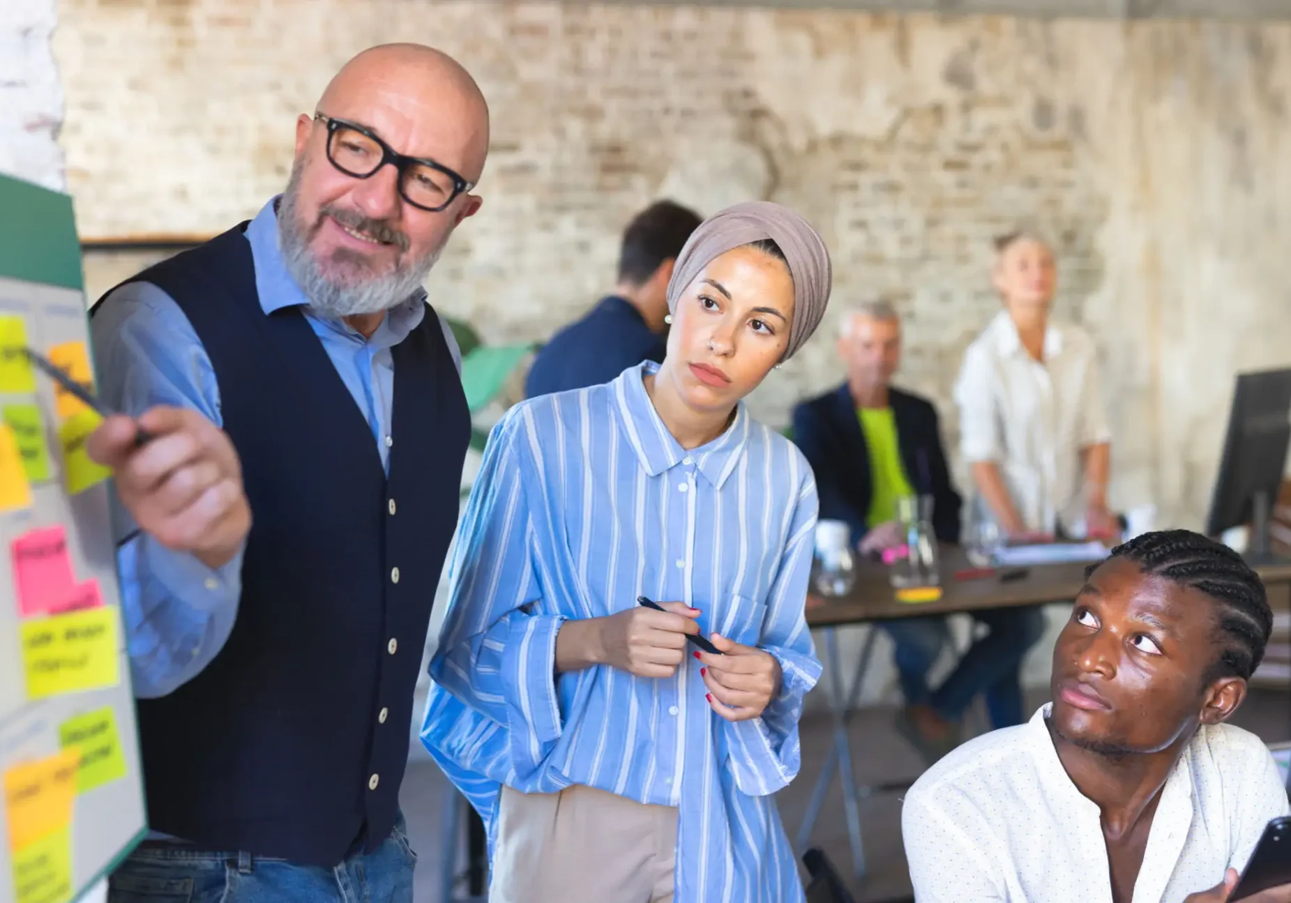 A group of people standing around each other.